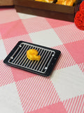 Tiny Twisty Fry Mini Taba Squishy from Mini Street Bites Series on a cute mini food display