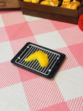 Sunny Crescent Dumpling Mini Taba Squishy from Mini Street Bites Series on a cute mini food display