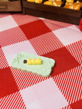 Butter Corn Skewer Plate Mini Taba Squishy from Mini Street Bites Series on a cute mini food display