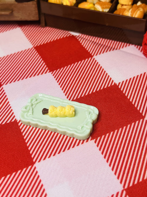 Butter Corn Skewer Plate Mini Taba Squishy from Mini Street Bites Series on a cute mini food display