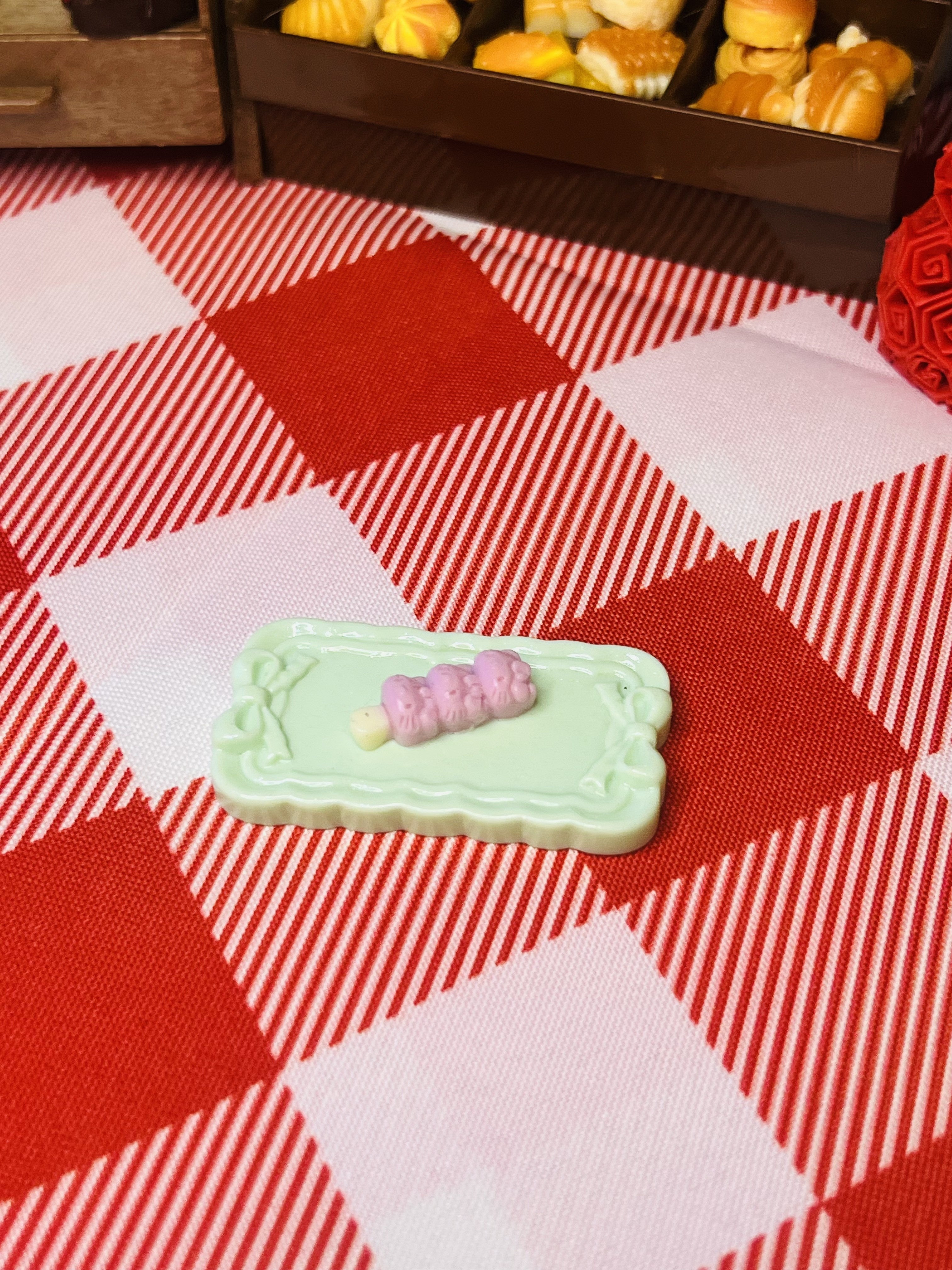 Blush Berry Mochi Plate Mini Taba Squishy from Mini Street Bites Series on a cute mini food display