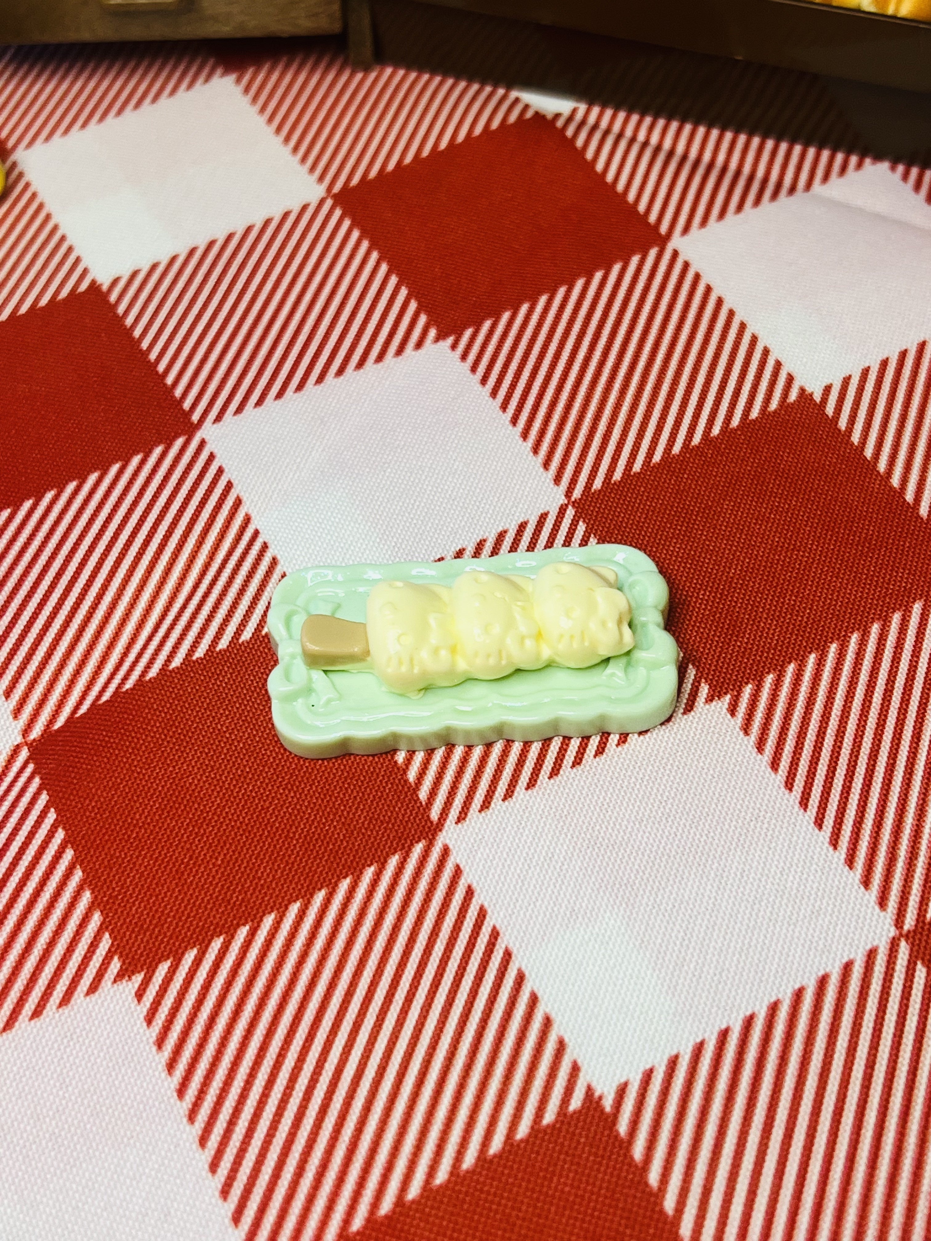 Creamy Corn Roll Plate Mini Taba Squishy from Mini Street Bites Series on a cute mini food display