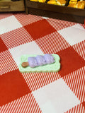 Lavender Mochi Stick Mini Taba Squishy from Mini Street Bites Series on a cute mini food display