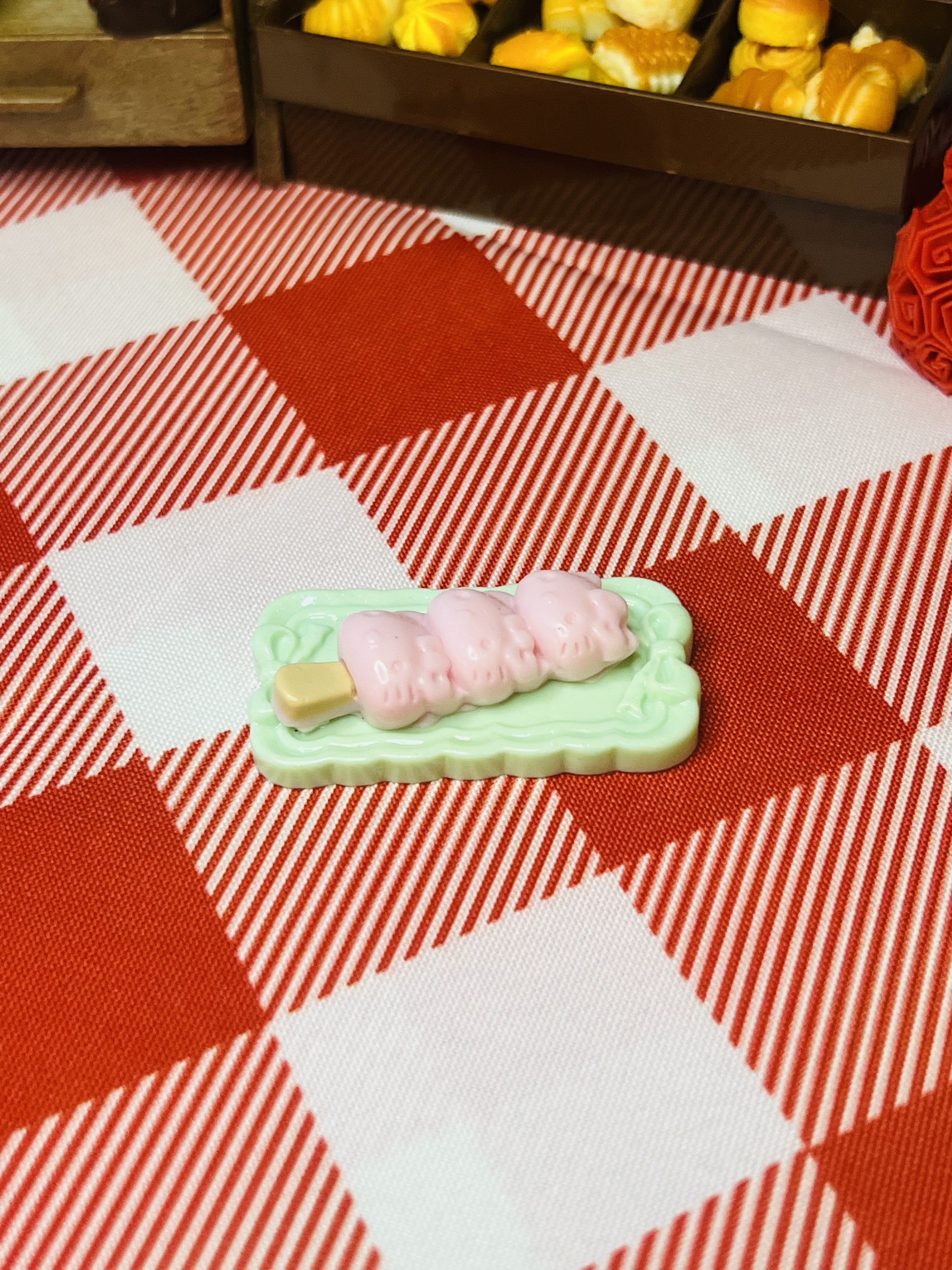 Peach Mochi Stick Mini Taba Squishy from Mini Street Bites Series on a cute mini food display